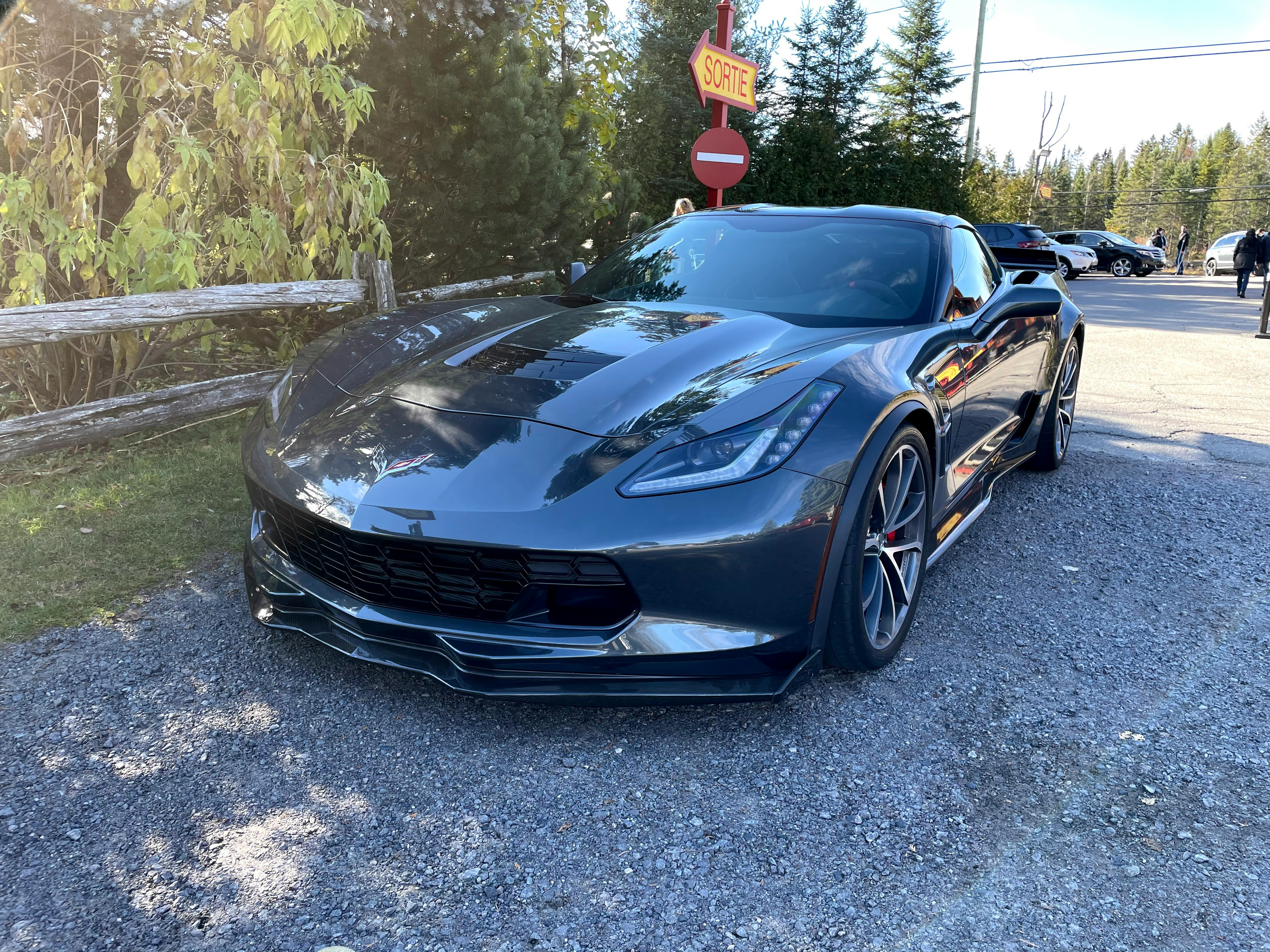 black porsche 911 parked on gray asphalt road during daytime